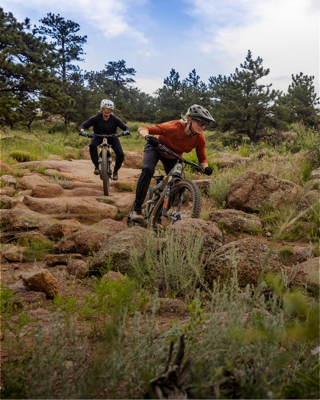 Two downhill mountain bikers going a rocky trail wearing PEARL iZUMi mountain bike gear.