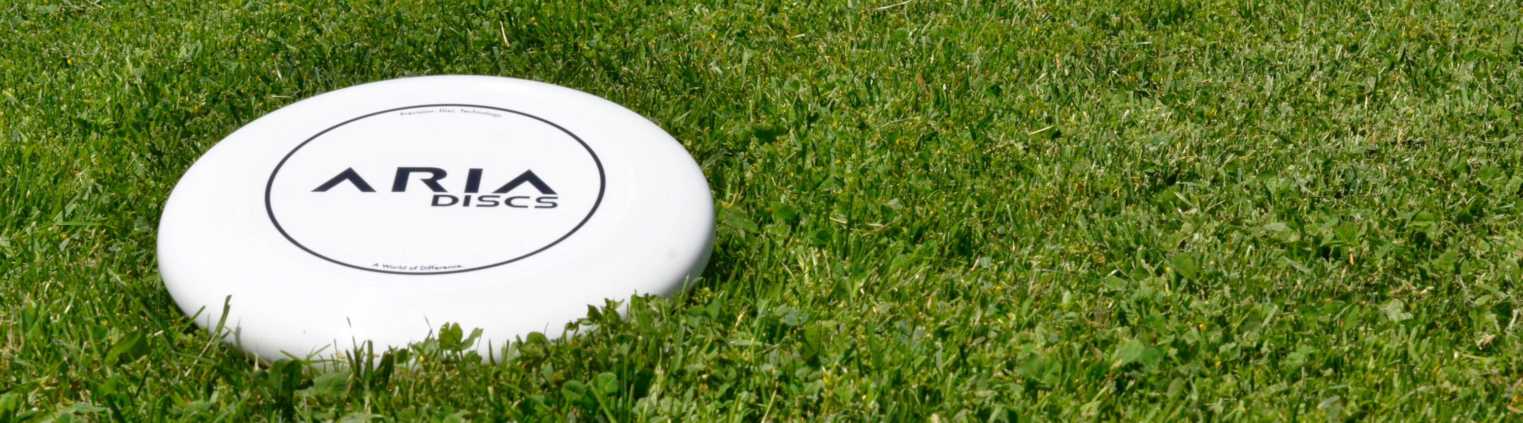 ARIA professional official ultimate flying disc for the sport commonly known as 'ultimate frisbee' disc picture on grass
