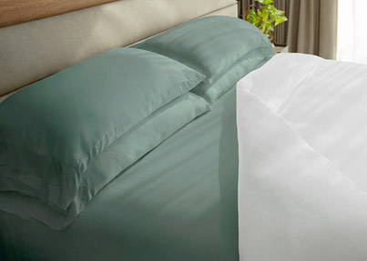 Teal colored classic bamboo sheets on a bed