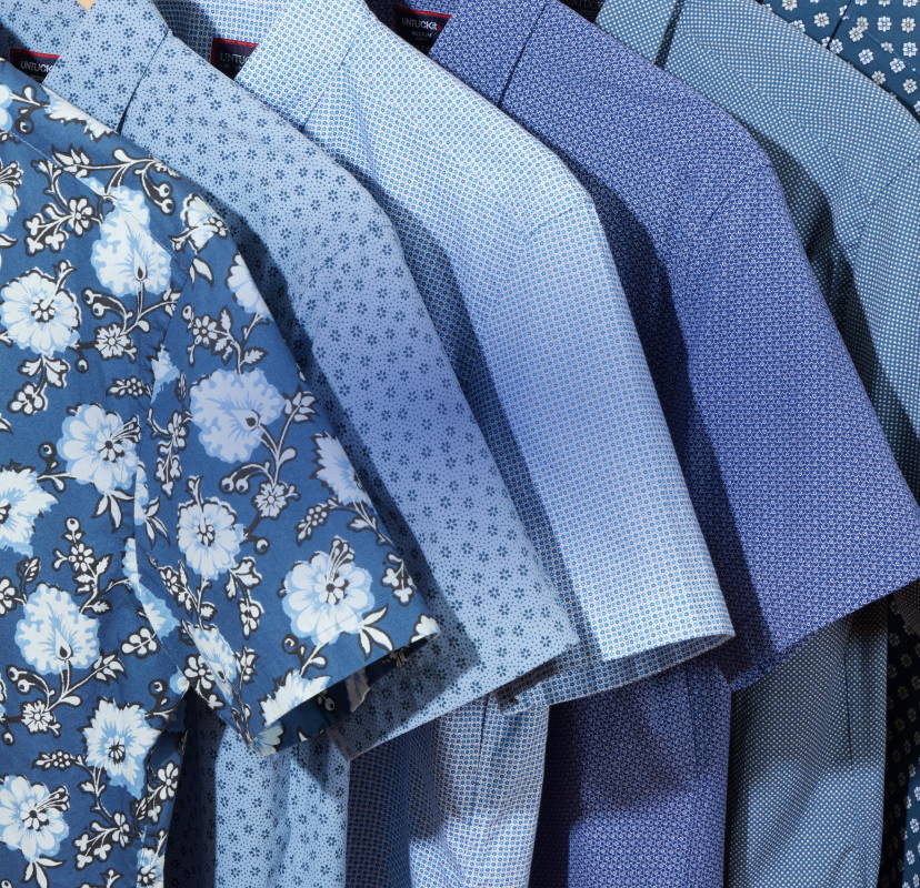 Collection of UNTUCKit short sleeve shirts in various colors. 