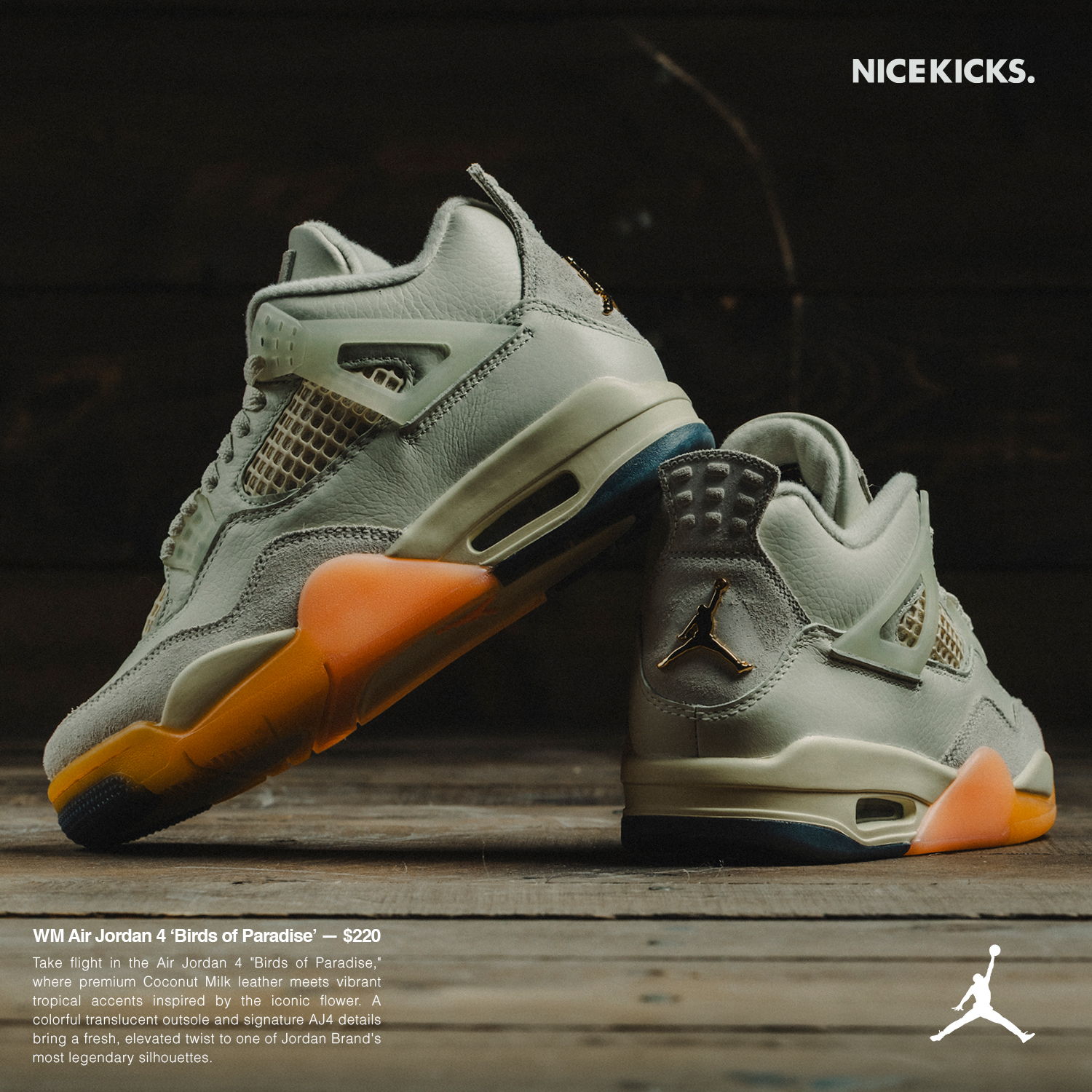 A pair of stylish gray and orange sneakers displayed on a wooden surface.