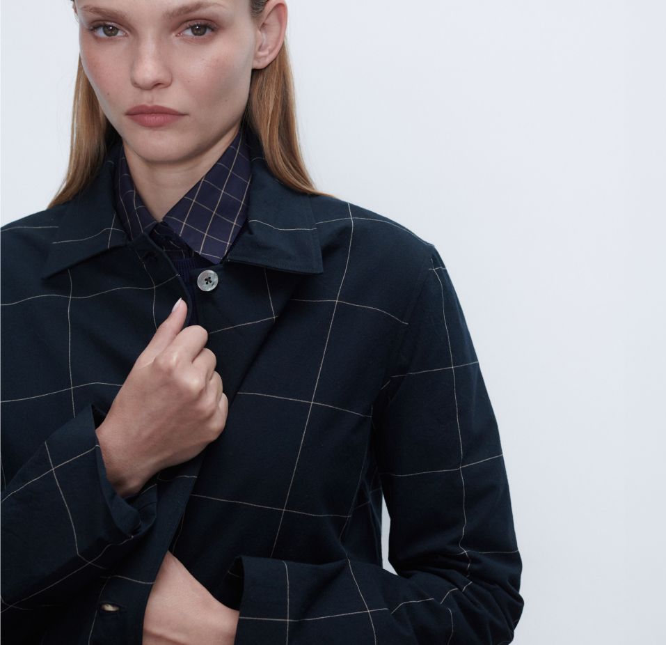 Woman with coat holding onto it