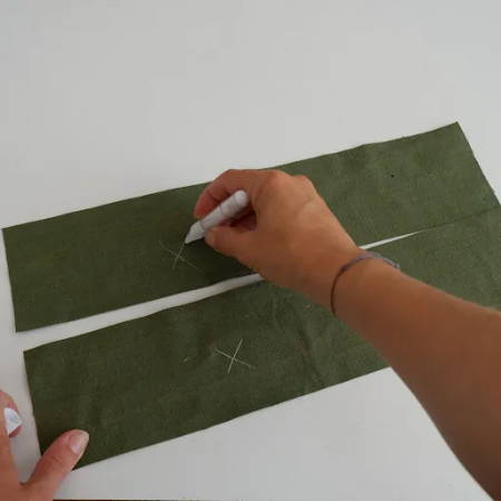 Hand marking the wrong sides of the fabric with a temporary fabric marker
