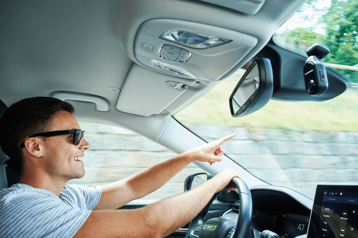 Nextbase dash cam mounted in a car with a man driving.