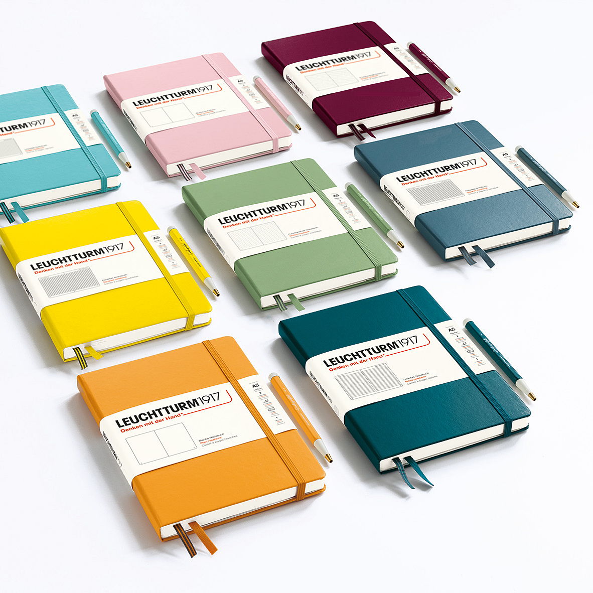 Colorful notebooks arranged in a grid pattern on a white background.
