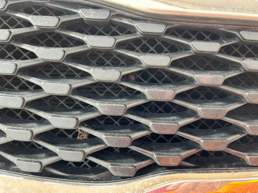 Close-up honeycomb radiator grille mesh on Jeff's 2016 Kia Optima photo 3