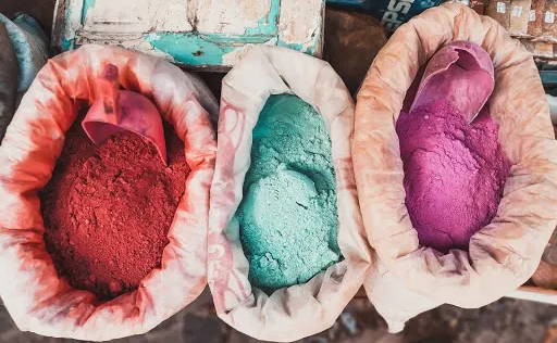 Three bags of brightly-colored low impact dye sit next to one another.