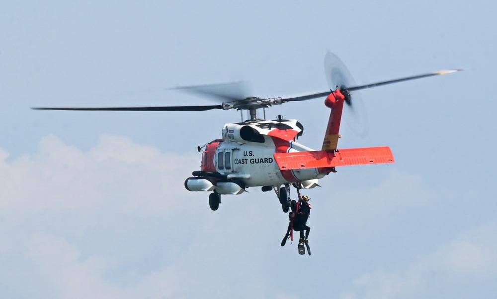 U.S. Coast Guard helicopter aircrew is pulled onto a Sikorsky MH-60T Jayhawk at Joint Base Langley-Eustis, Virginia, Sept. 15, 2022. The HH-60J Jayhawk is a medium-range recovery helicopter used to perform search and rescue, law enforcement, military readiness and marine environmental protection missions. (U.S. Air Force photo by Airman 1st Class Mikaela Smith)