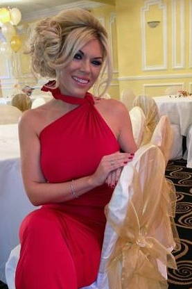Woman in red dress at a wedding table.