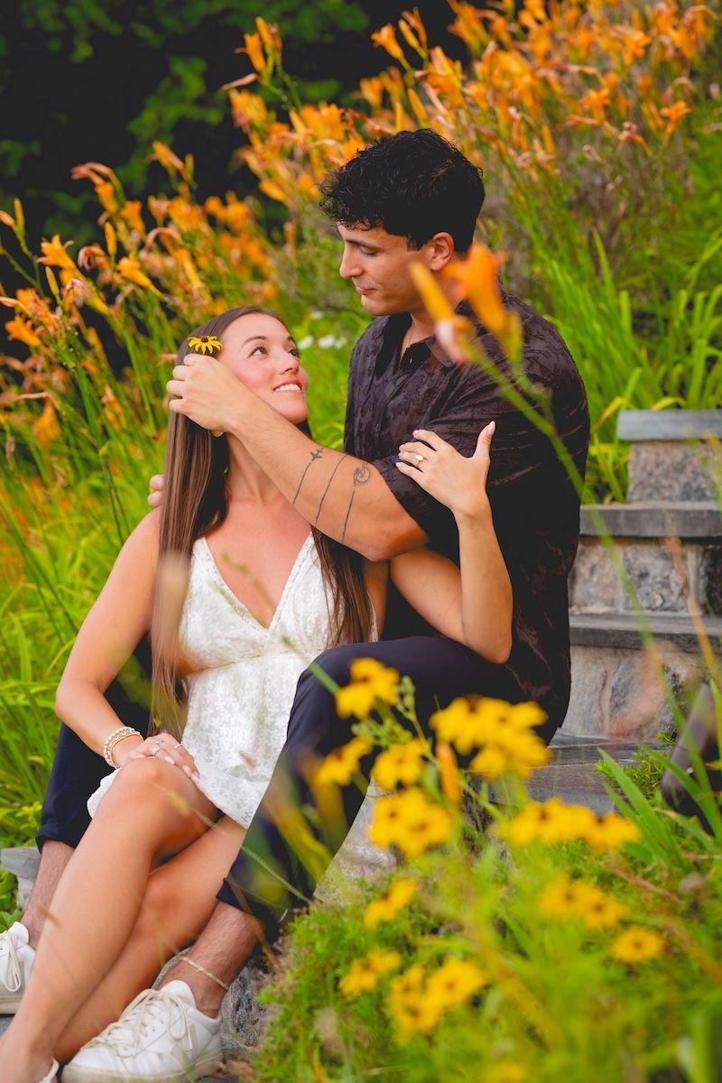 engaged couple in front of flowers, candlewood lake, ct