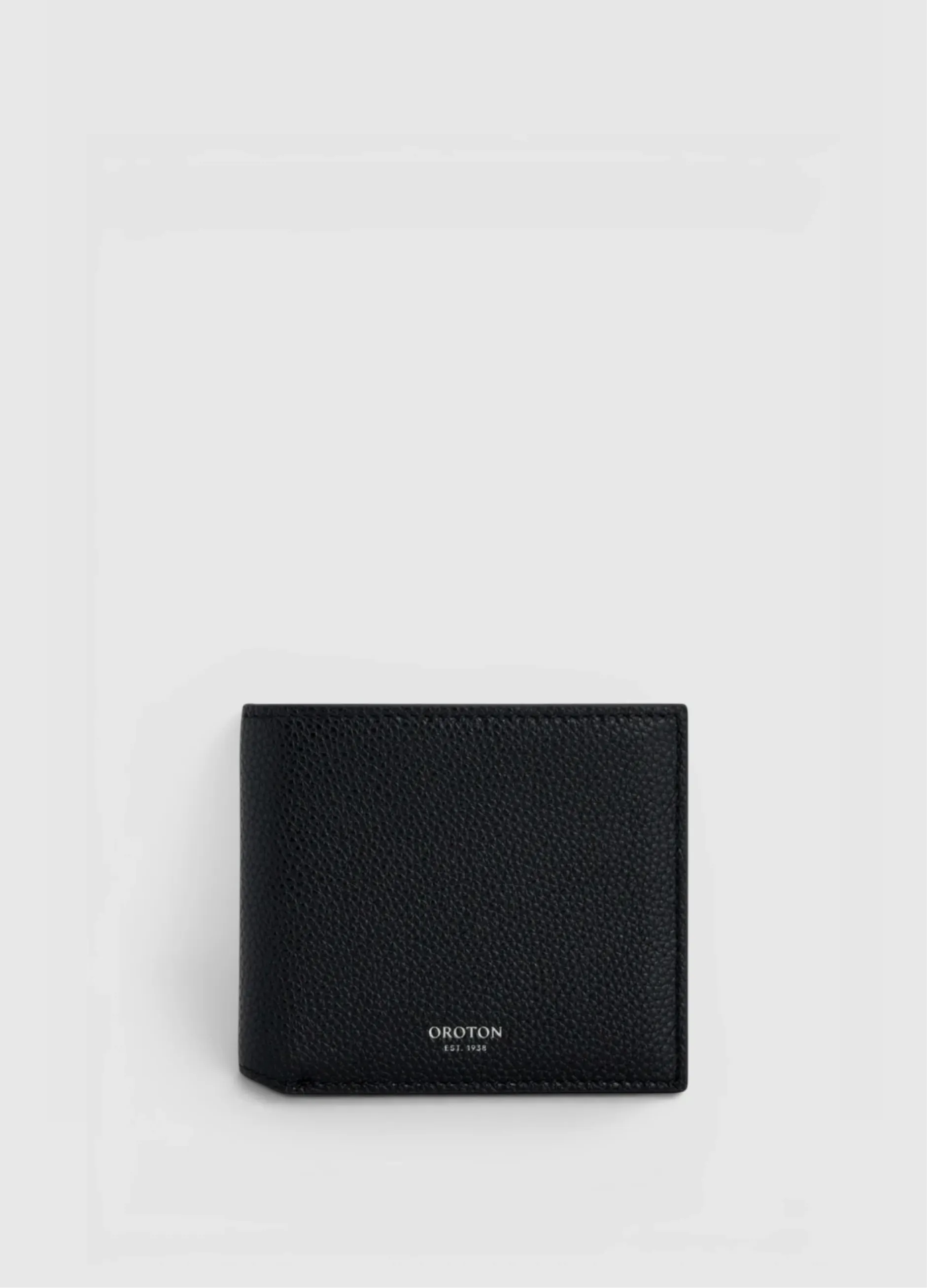 Black leather wallet on a light background.