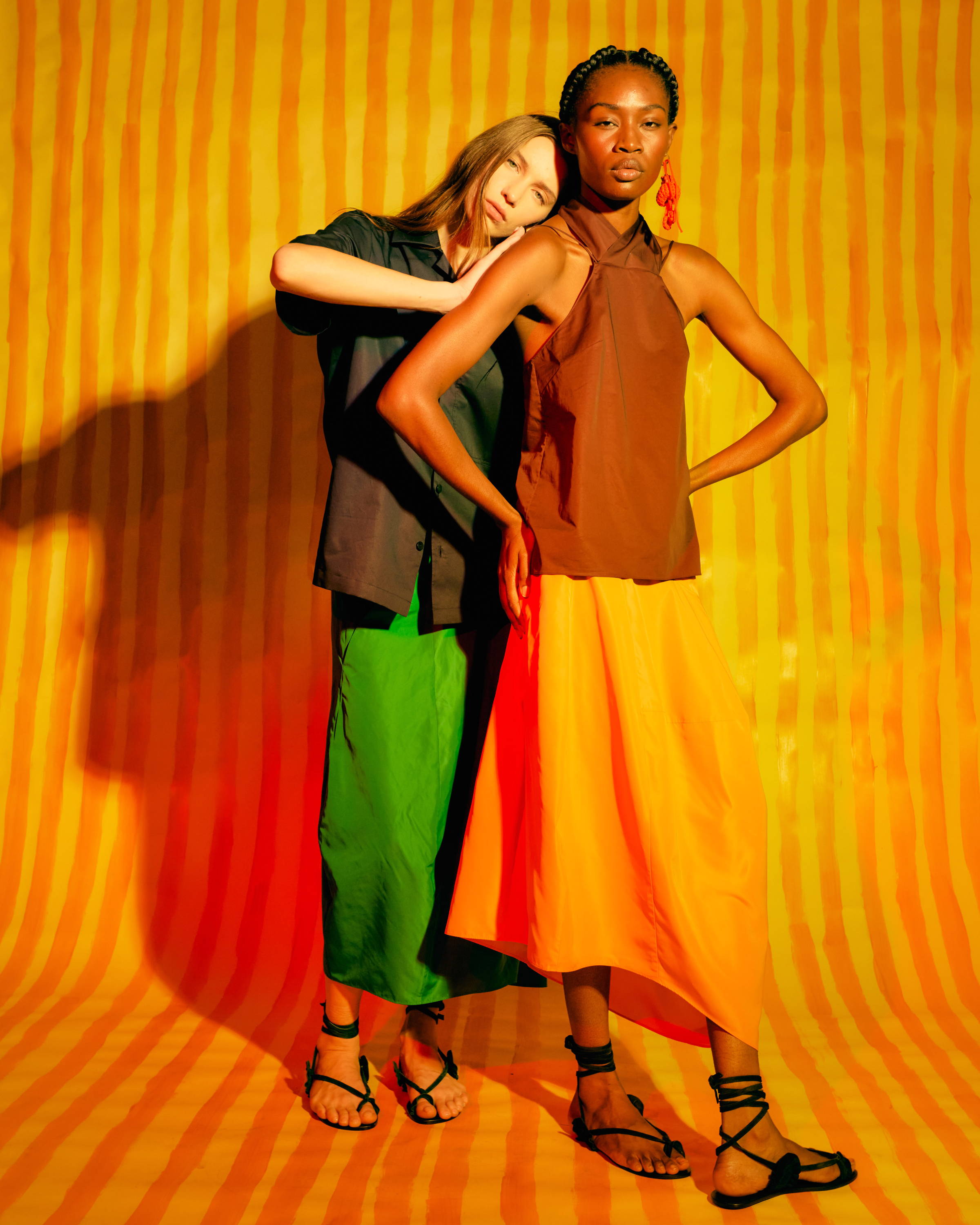 two models in front of striped background