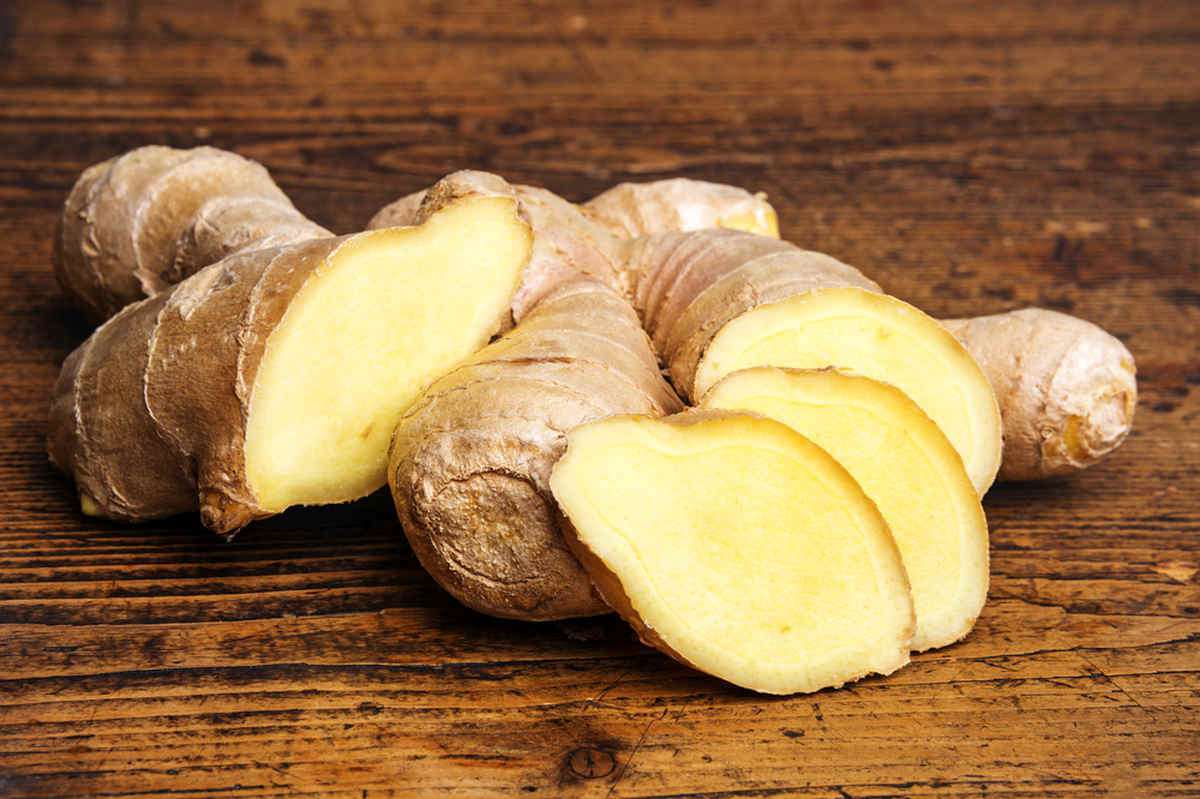Raw ginger on a wooden background  | Foods For Sinus Health & Ways To Relieve Infection | relieving sinus pressure naturally