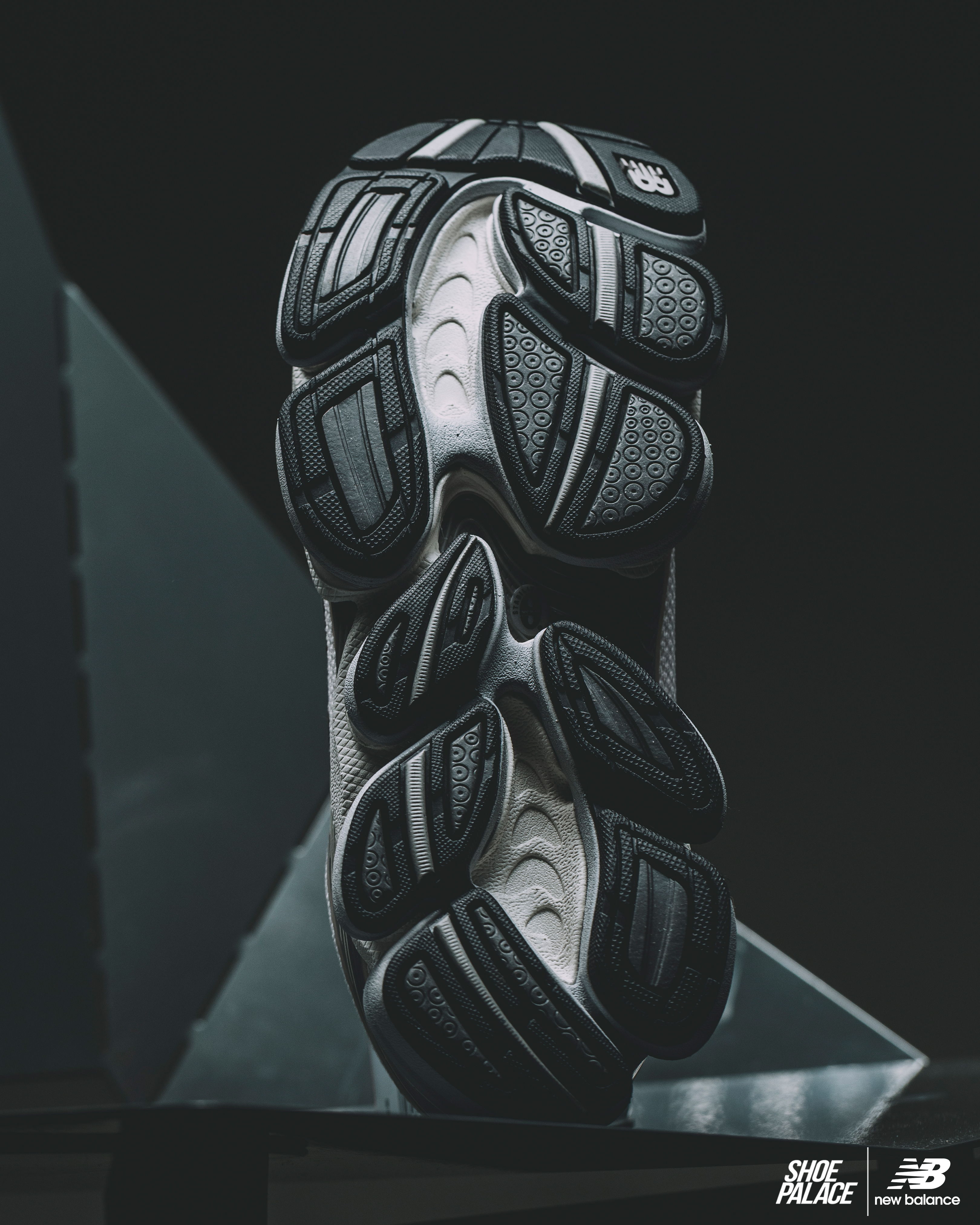 Sole of a sneaker with a textured black and white design.