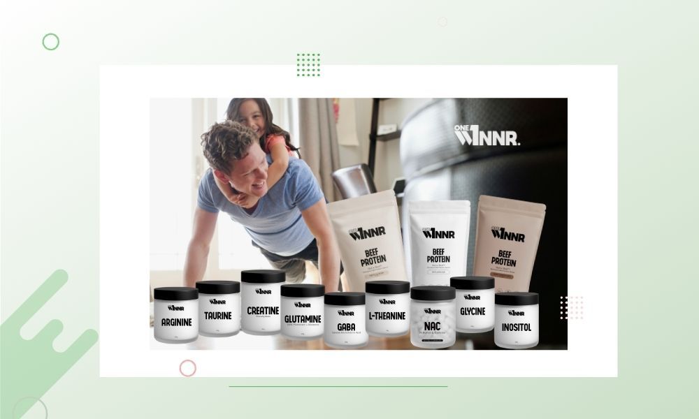 A man doing push-ups with a woman on his back and supplement products displayed.