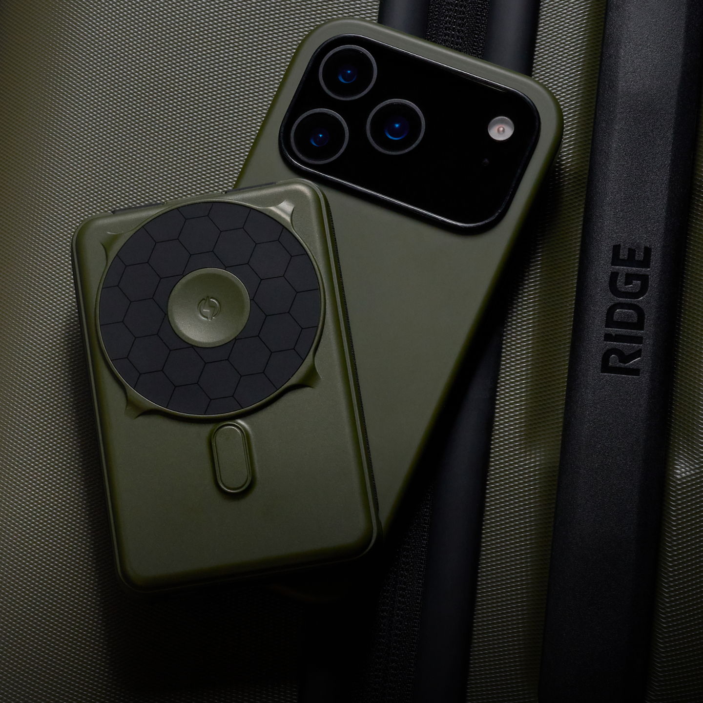 A smartphone and accessory on a textured surface.