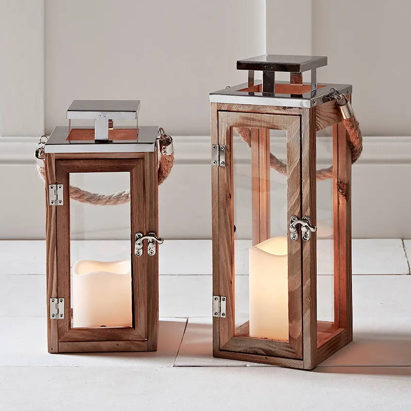 Two Salcombe wooden lanterns positioned indoors on the floor