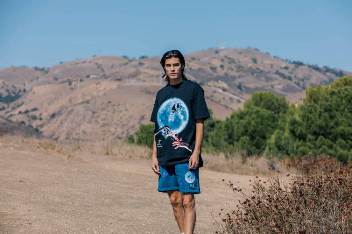 male model in shoe palace x et apparel with hills in background
