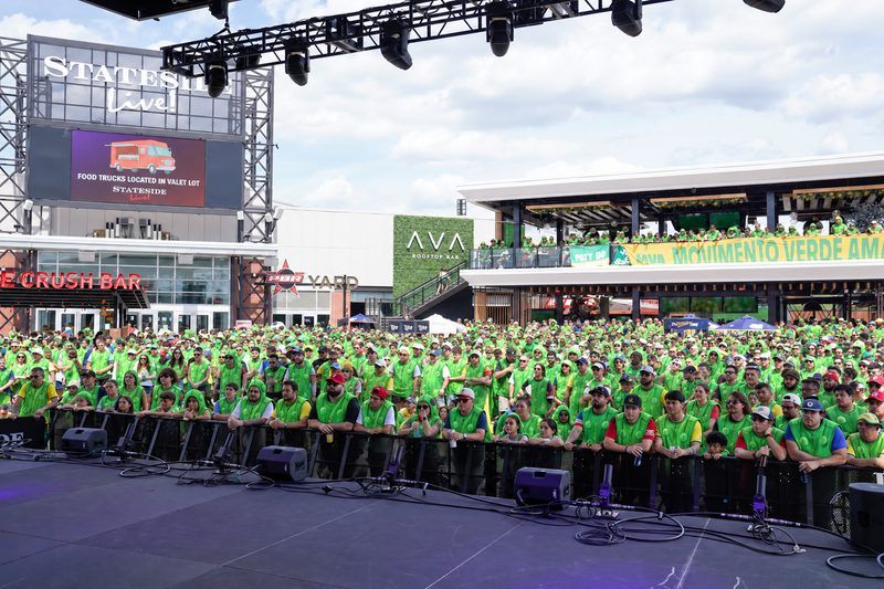 Crowd dressed in green packed in front of the stage at Stateside Live! in Philadelphia, a preview of the world record pickle suit attempt at The Big Dill® Philadelphia pickle party on National Pickle Day