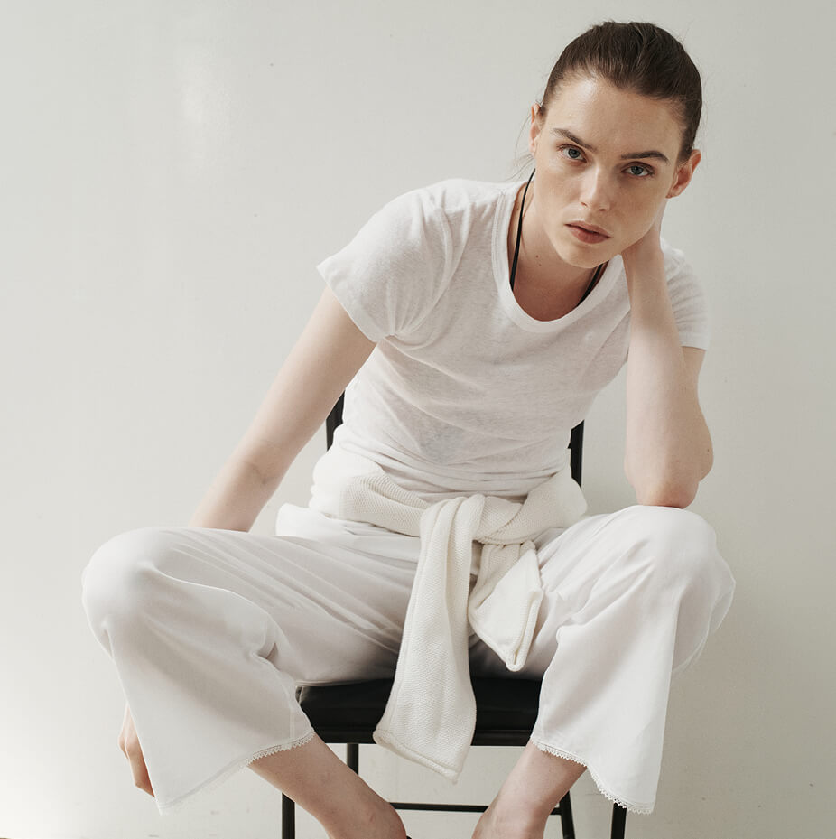 Woman sitting in chair leaning over