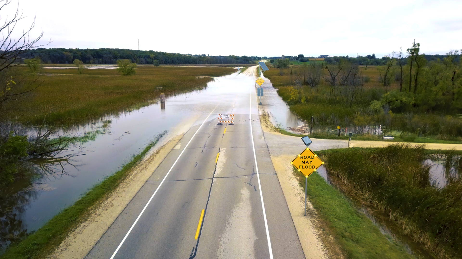 A high water warning system placed strategically ahead of a commonly flooded road.