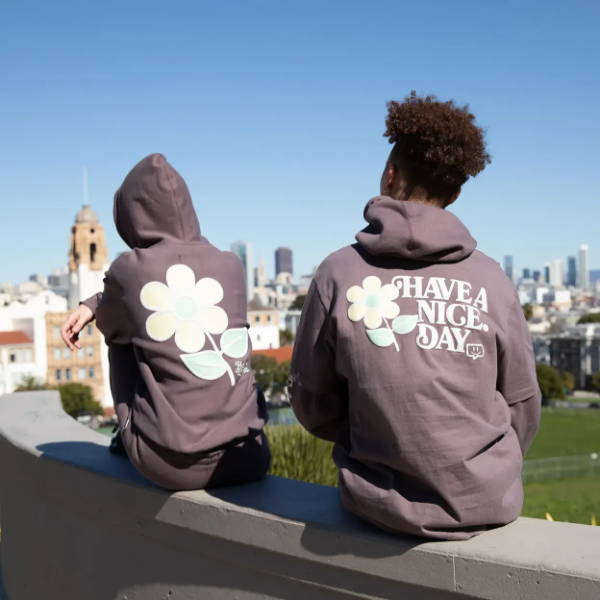 male and female on ledge wearing have a nice day apparel