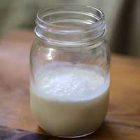 A jar half filled with white liquid
