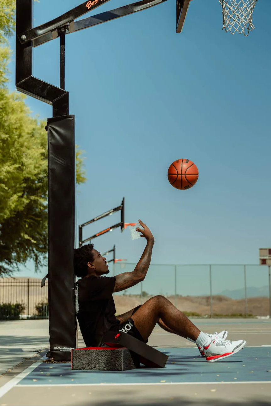 male model in aj3 retro og fire red throwing a basketball