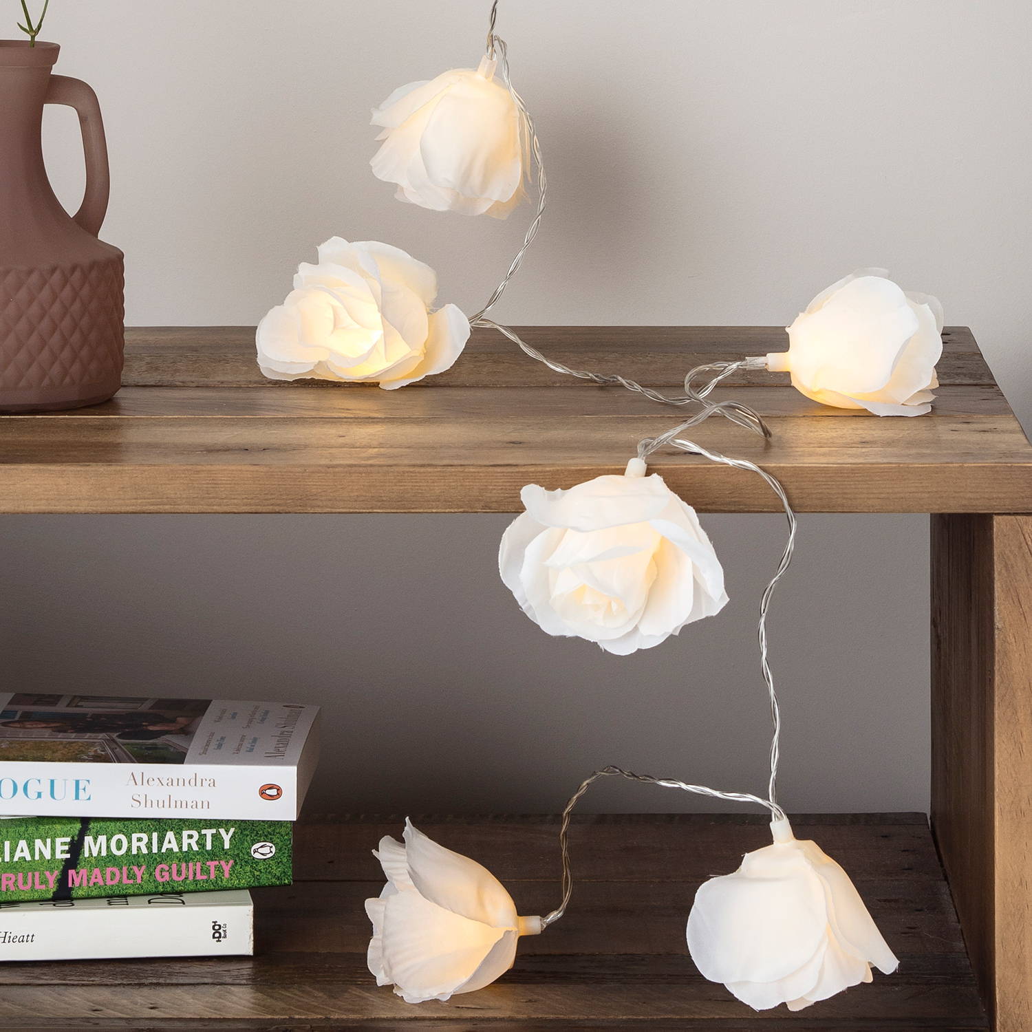 Rose shaped fairy lights draped across table