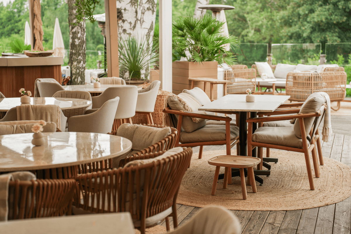 Hospitality outdoor dining space with mixed restaurant patio furniture, lounge seating and covered terrace areas 