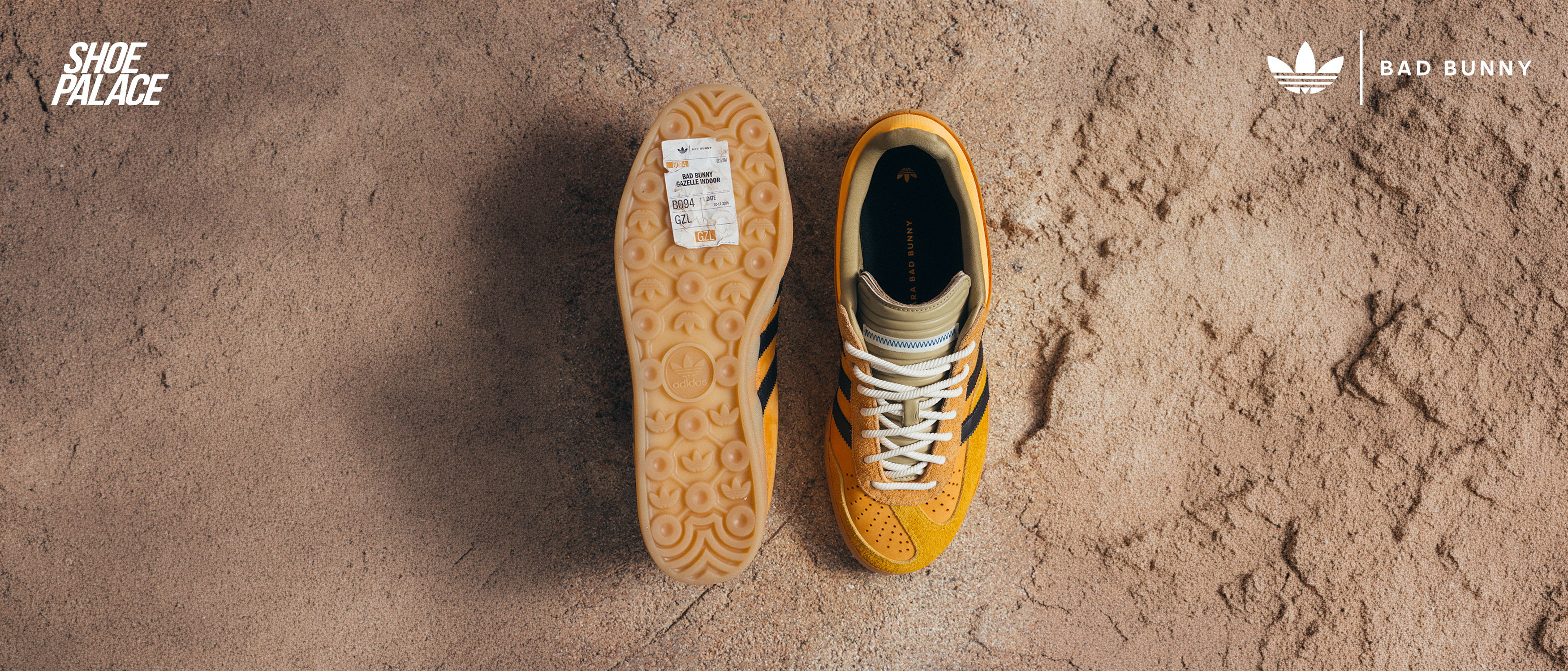 A pair of yellow sneakers on a textured surface.