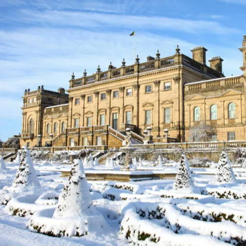 An image of the gardens at Harewood House covered in snow.