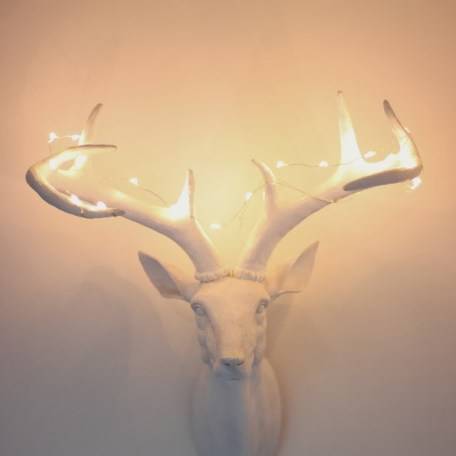 Antler statue with fairy lights on the antlers.