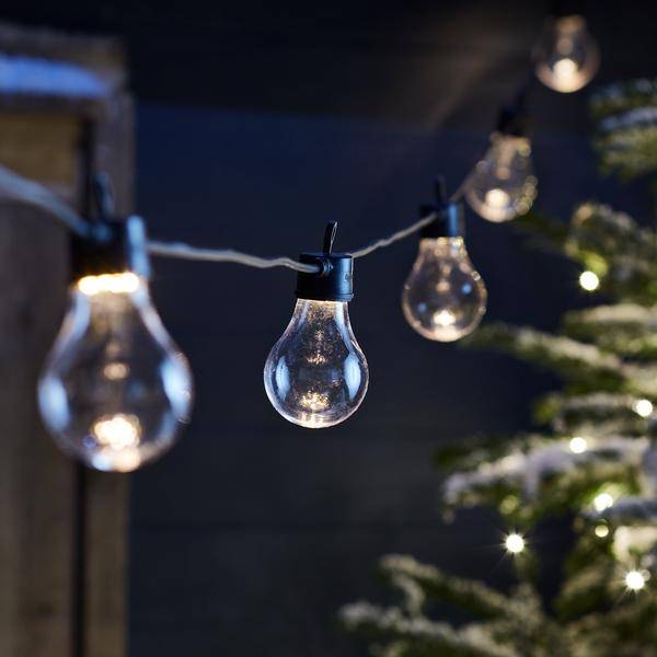 Festoons on a black cable in an outdoor Winter setting.