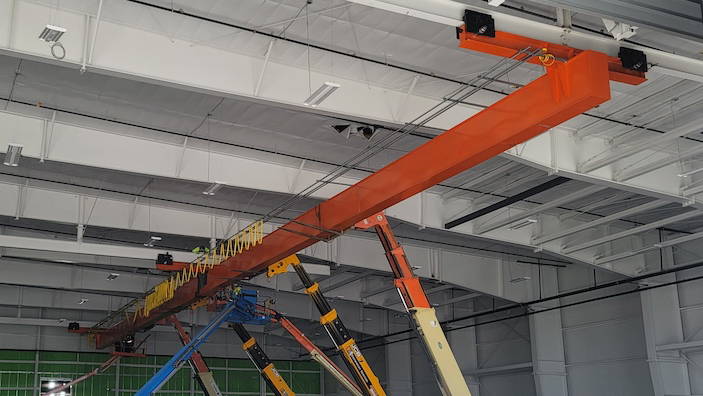 industrial worker welding a custom fabricated crane