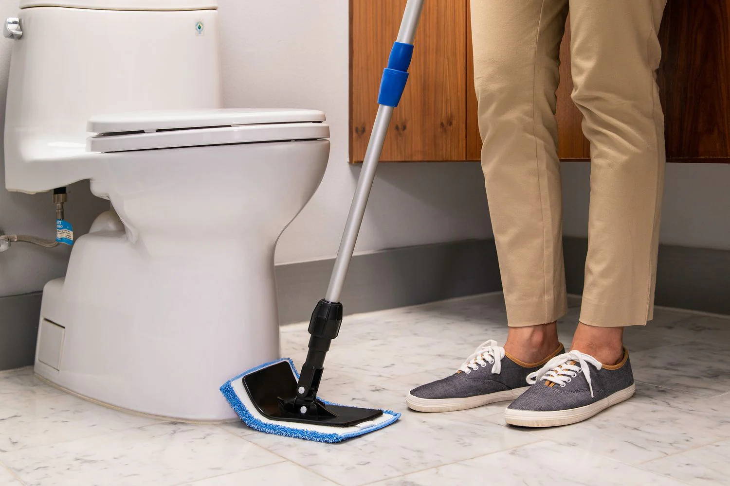 person cleaning near toilet with Contour Frame mop
