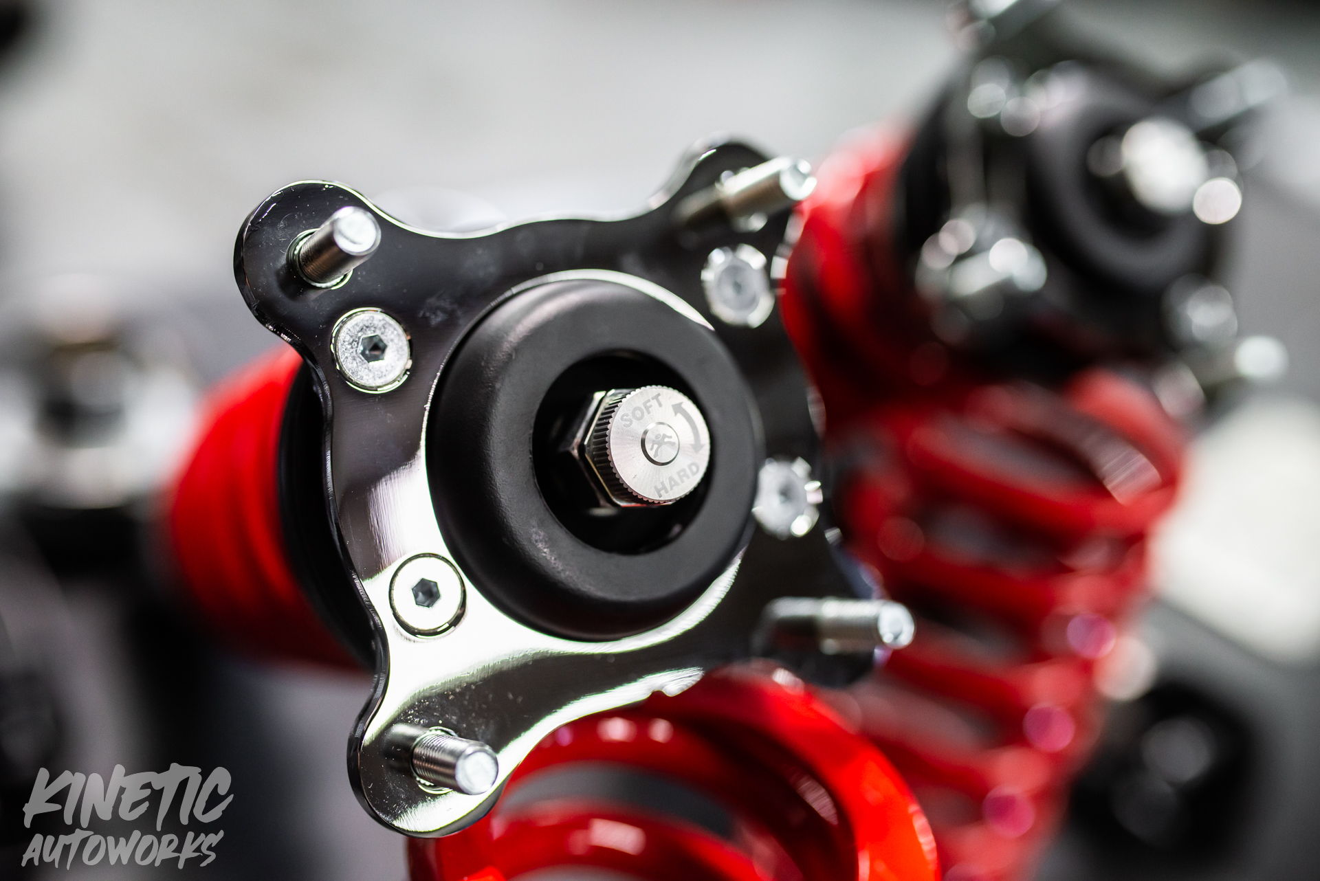 Adjustable coilover top mounts and springs photographed at Kinetic Autoworks