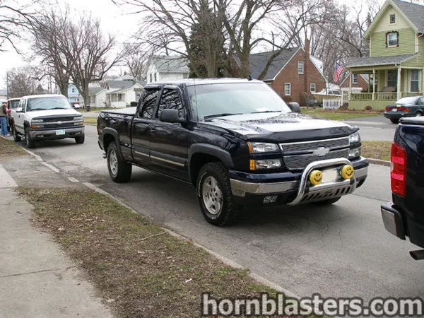 Front three-quarter view of Jerry's dark blue 2006 Chevrolet Silverado 1500 Extended Cab parked curbside with a chrome bull bar, install photo 1