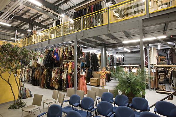 Cogan mezzanine used for storage at retail location with yellow mesh handrails.