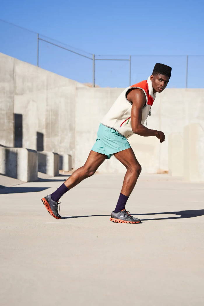 male model wearing on running shoes in sprint position