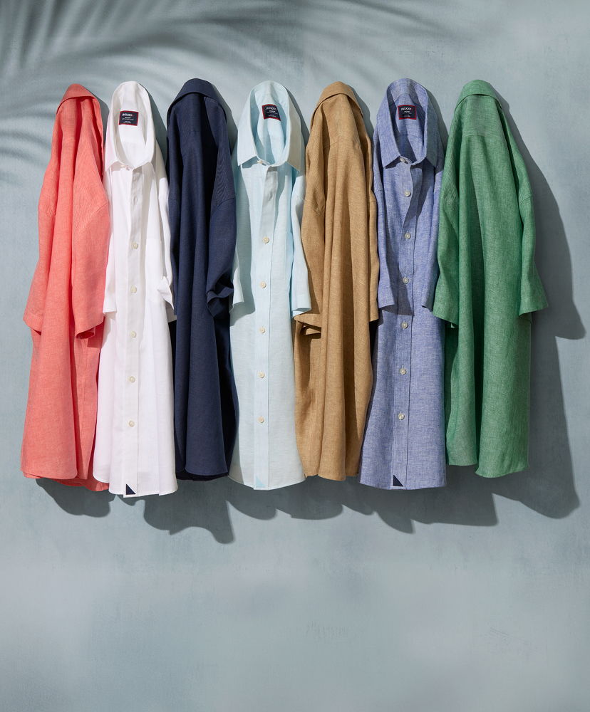A row of colorful shirts hanging against a light background.