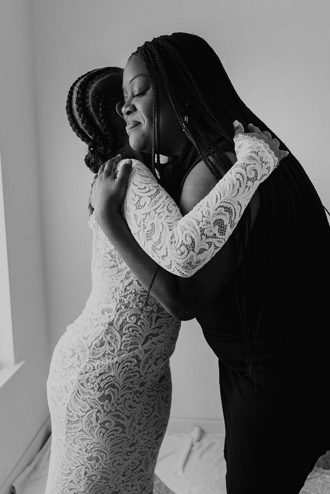 Bride hugging friend before ceremony