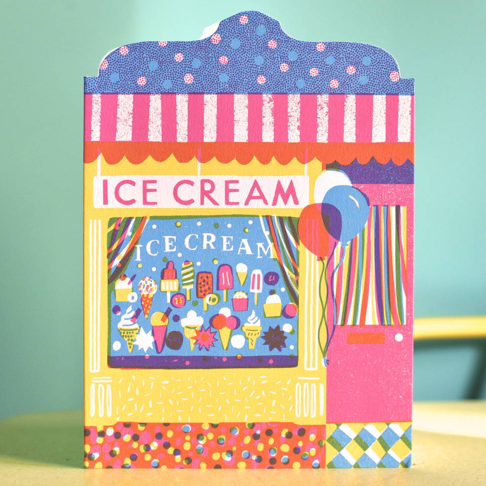 a card of a brightly coloured ice cream shop front.