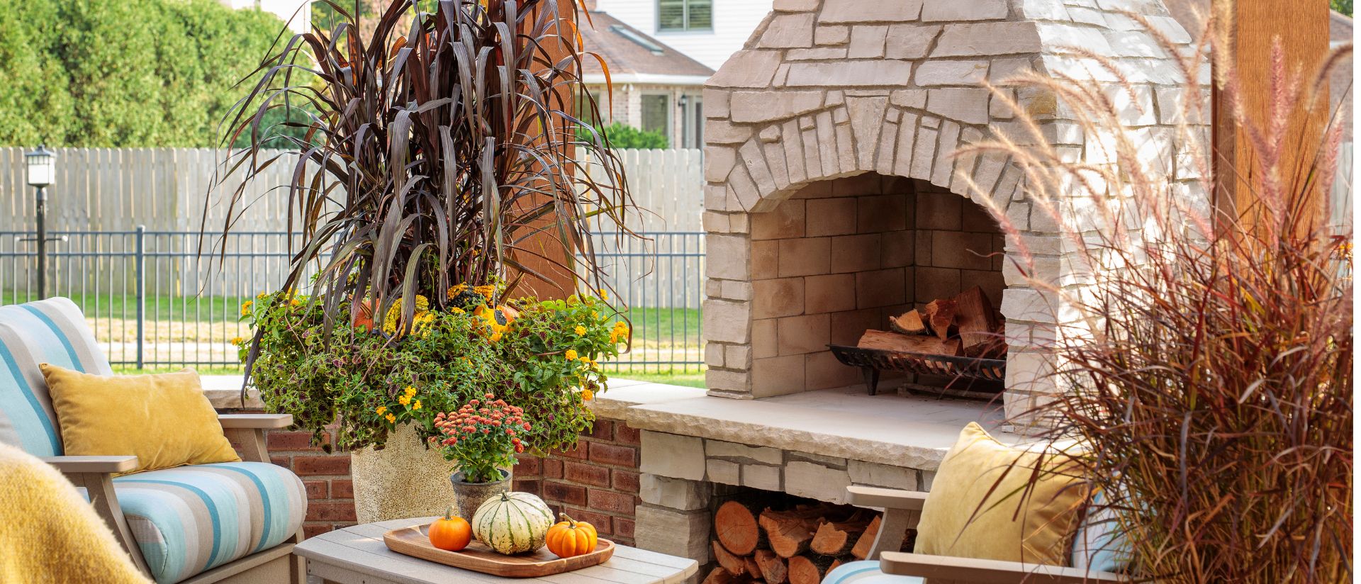 Scene of backyard fireplace patio with Luscious® Goldengate™, Graceful Grasses® Purple Fountain Grass, ColorBlaze® Chocolate Drop, Graceful Grasses® Vertigo®