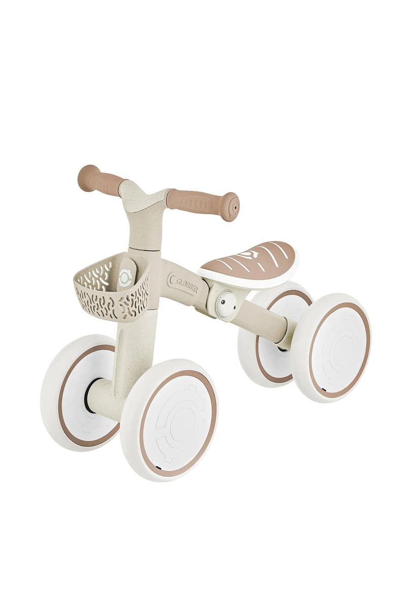 A children's tricycle with a beige and white color scheme.
