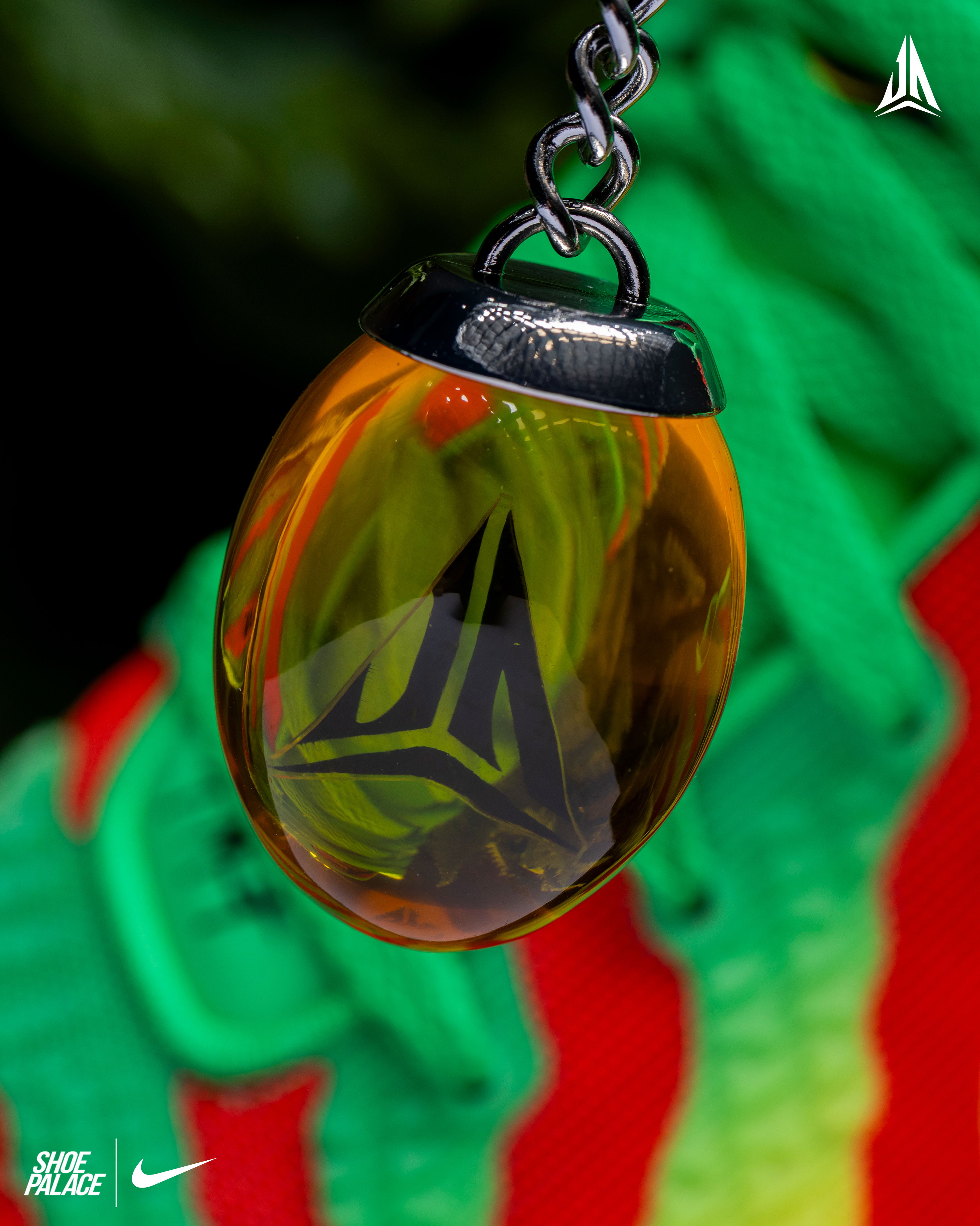 A close-up of a pendant on colorful sneaker laces.