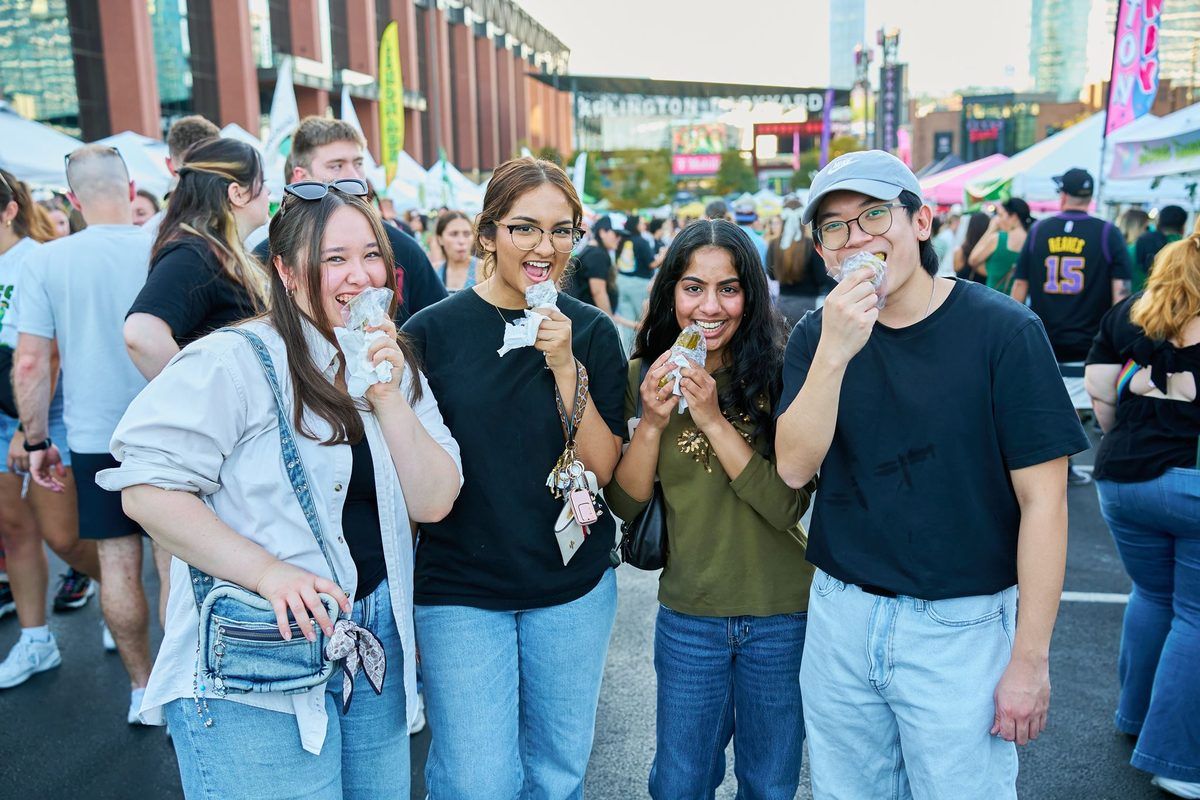 Friends eating pickles together at The Big Dill pickle festival at Texas Live! in Arlington Texas