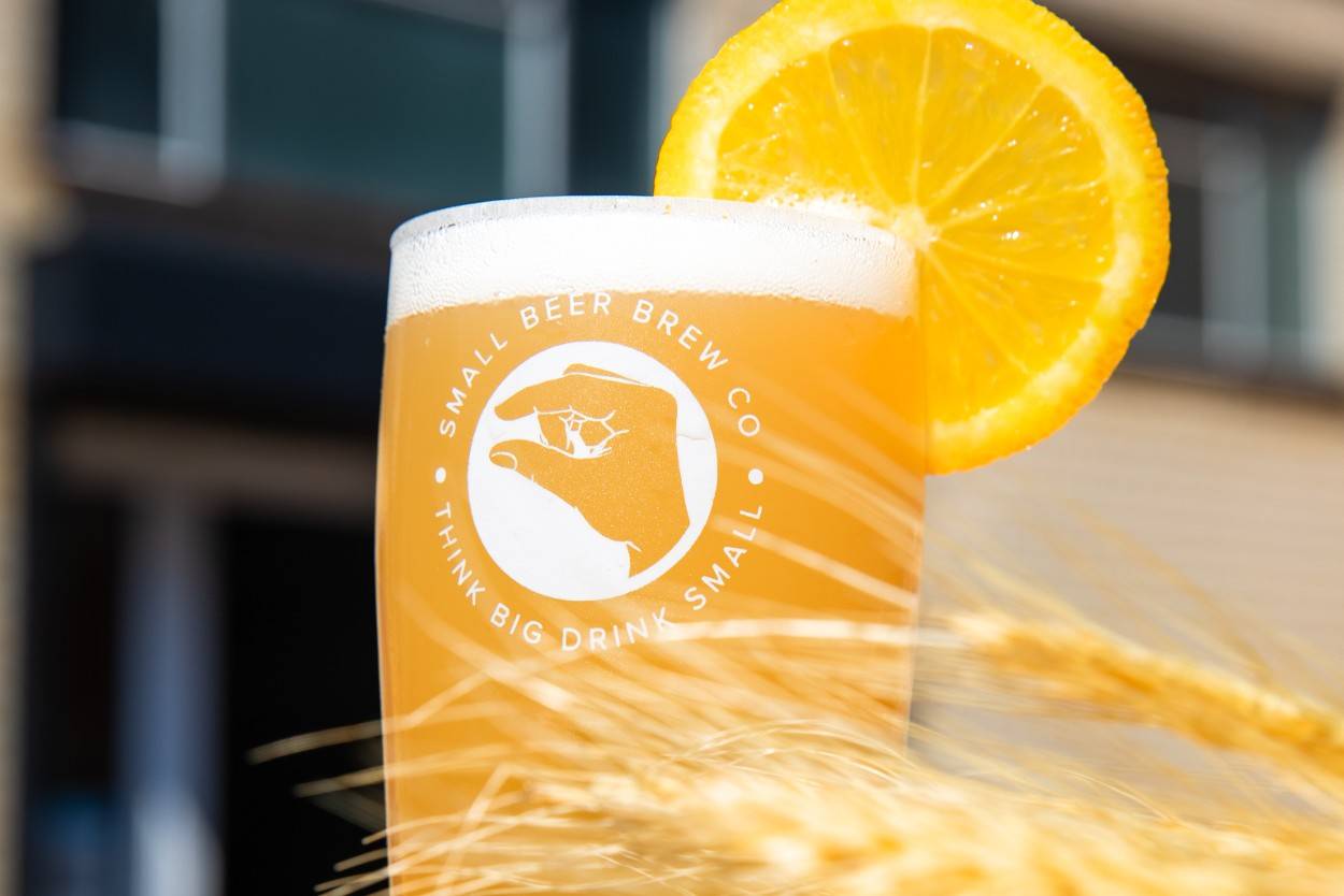 Belgian style witbier in a glass with a slice of orange