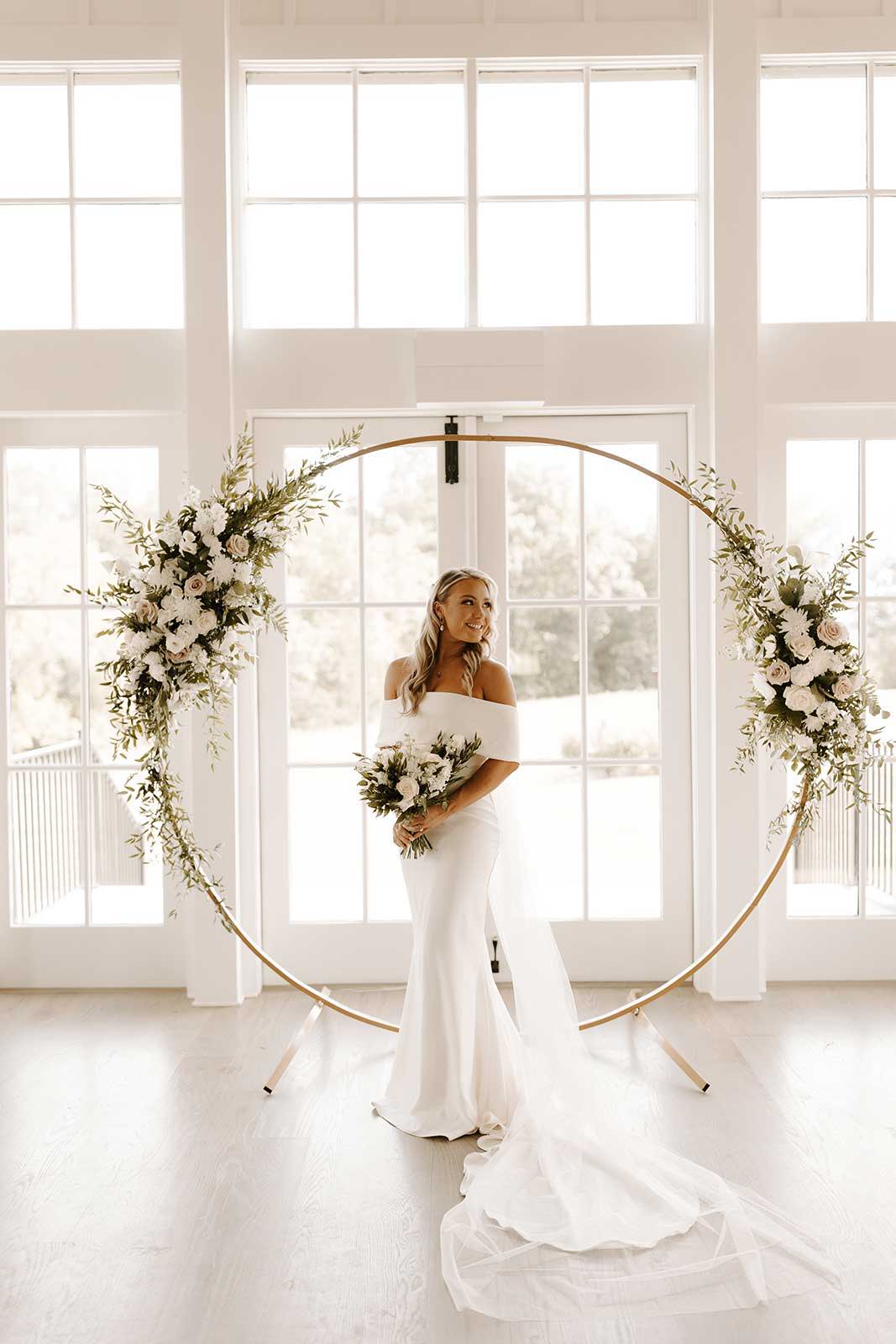 Bride in front of floral arrangement