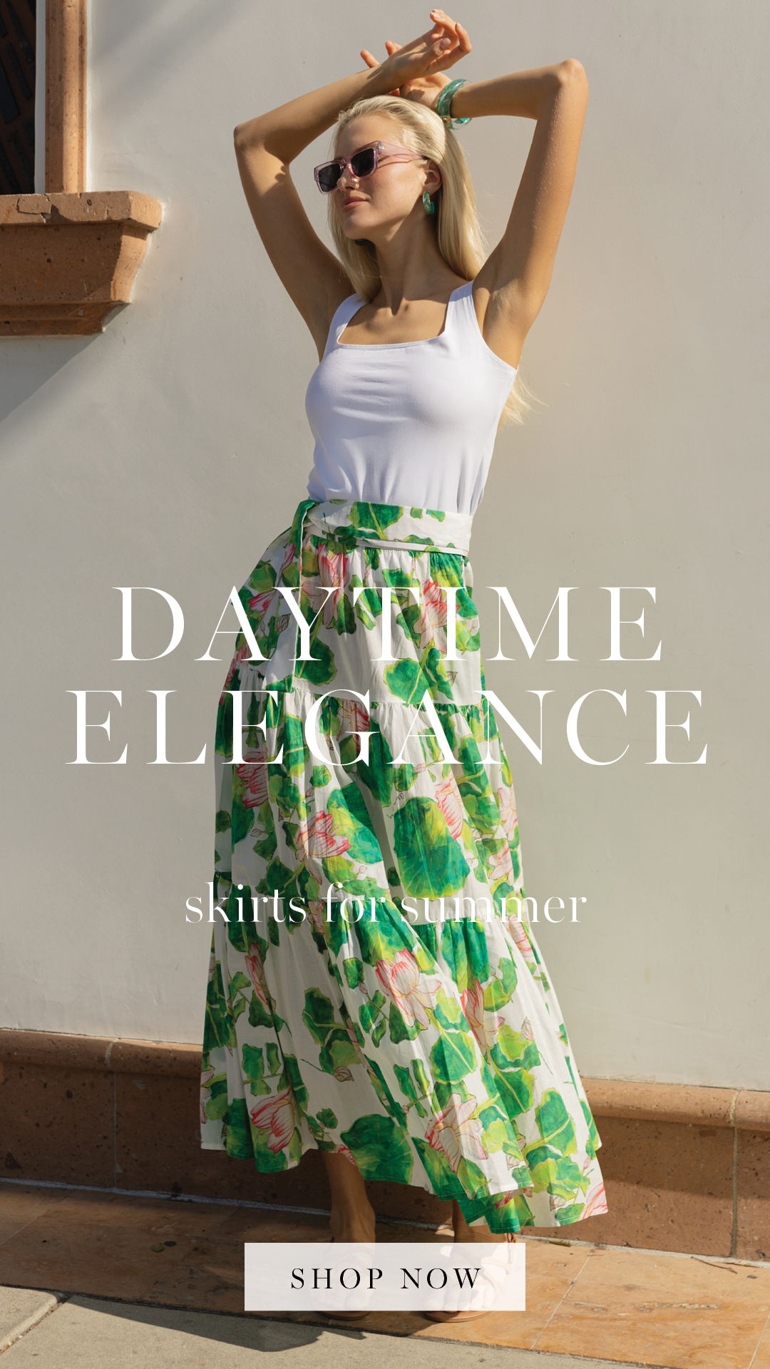 A woman in a long floral skirt poses outdoors, promoting summer skirts.